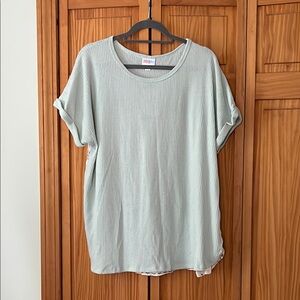 Mixed media dolphin hem top